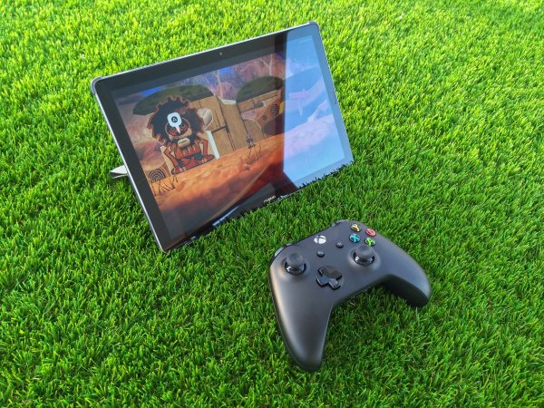 Samsung tablet on green grass with an xbox controller next to it