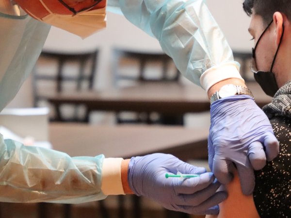 a healthcare worker giving a vaccine to a patient