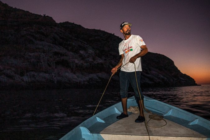 fisherman holding a rope on a boat