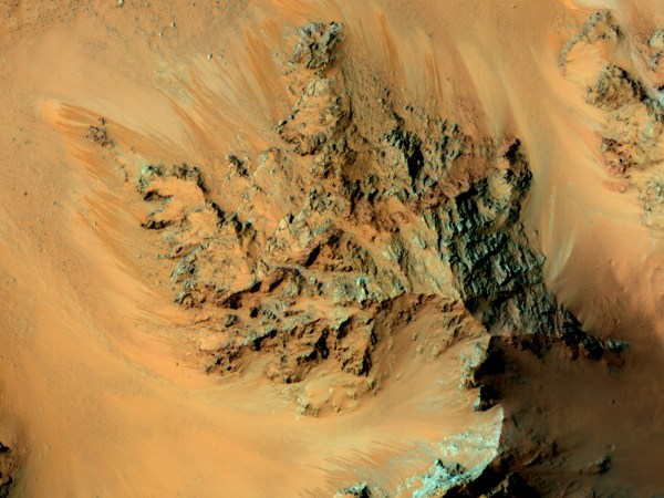 An overhead view of Mars featuring peculiar dark streaks.