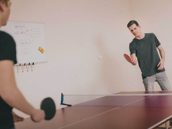 Men playing ping pong.