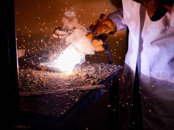 Using welding gloves while welding.