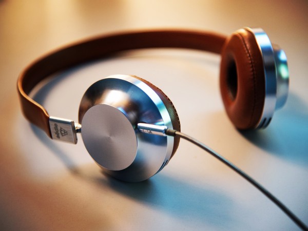 Vintage looking chromed headphones on a table.