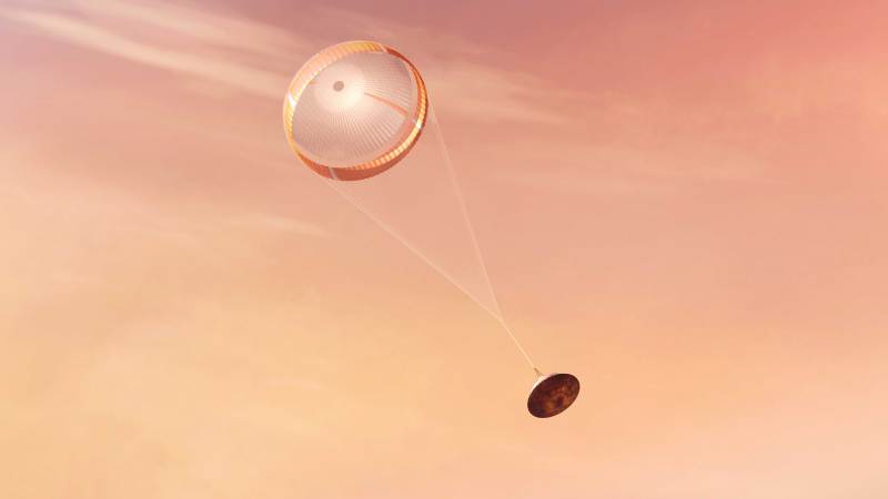 An artist's interpretation of Perseverance, NASA's newest Mars rover, parachuting down from orbit.