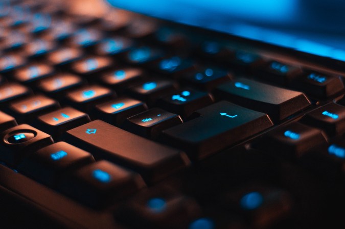 closeup of black gaming keyboard with blue backlight