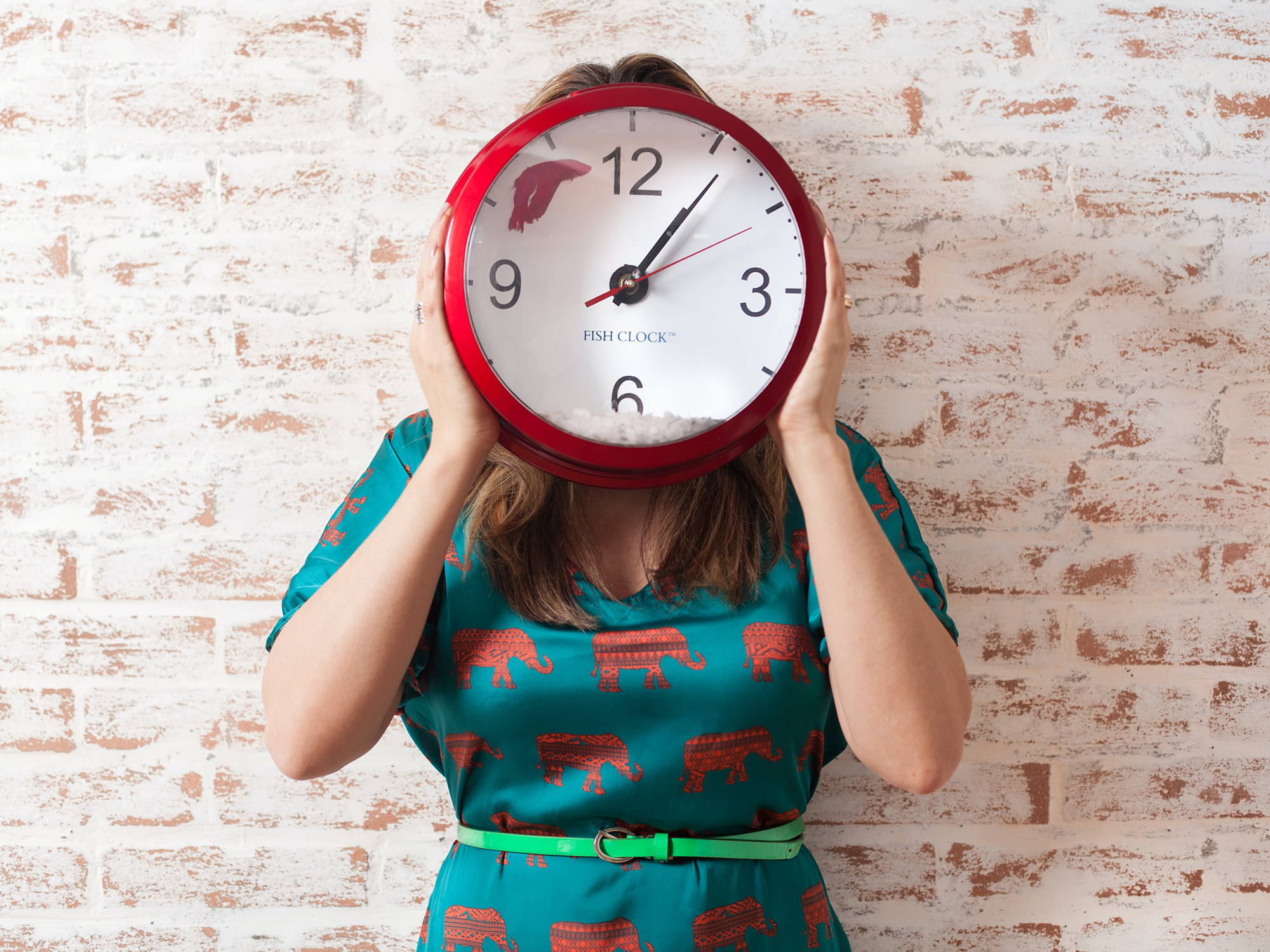 Person holding a clock