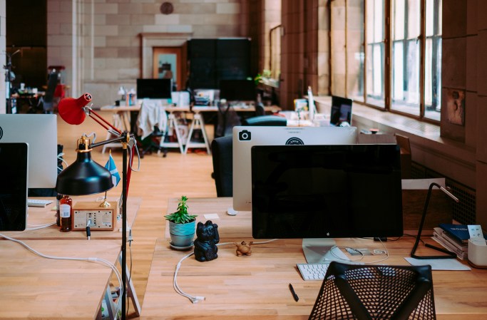 computers in an office on wooden desks