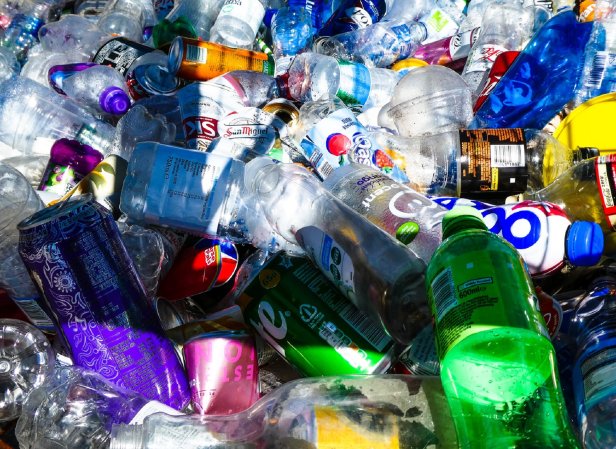 Plastic water bottles and aluminum soda cans in a bin