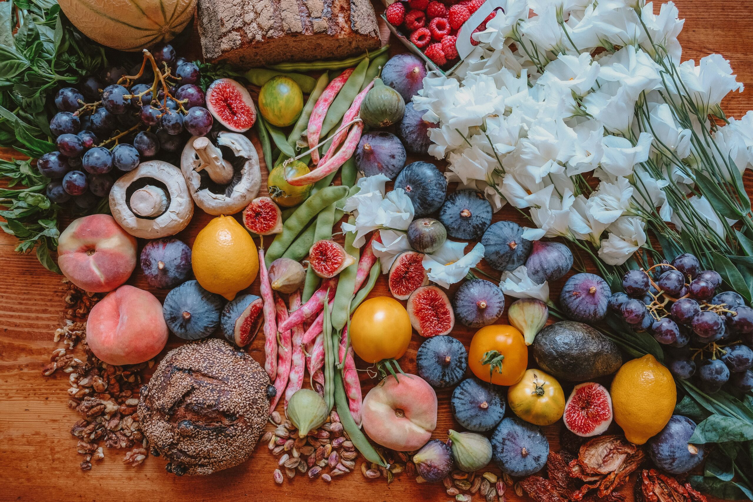 Assorted fruits, mushrooms, vegetables and other food spread out on table