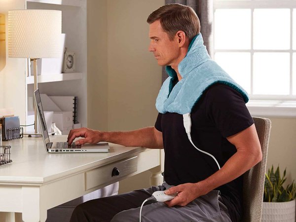 Man wearing neck heating pad