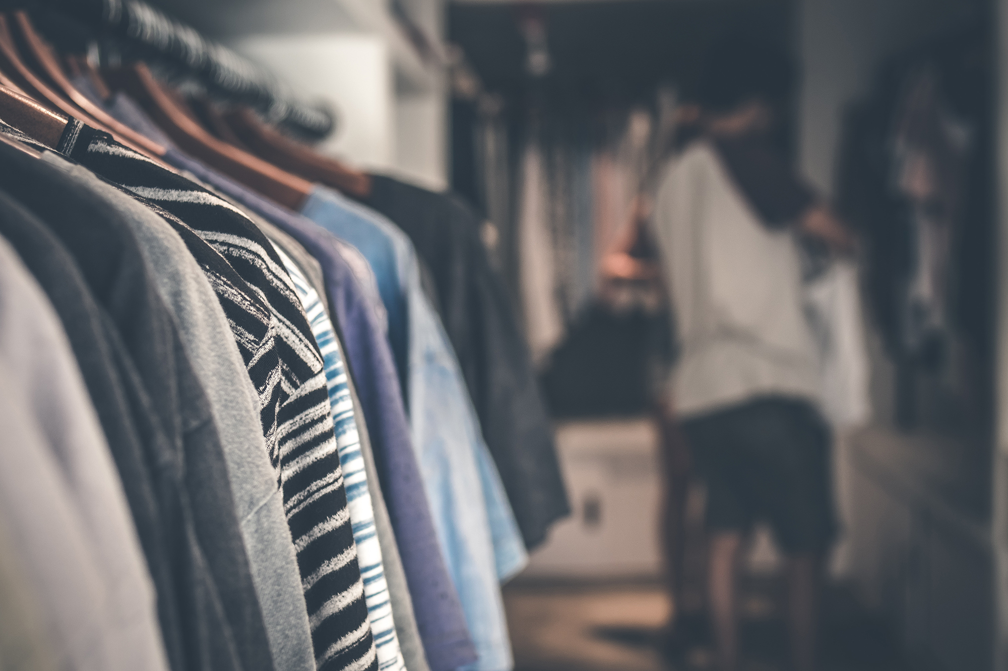 clothing on hangers in a walk-in closet with the best closet organizer.