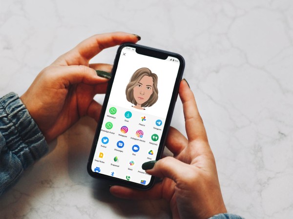 Person holding phone with avatar generator on screen