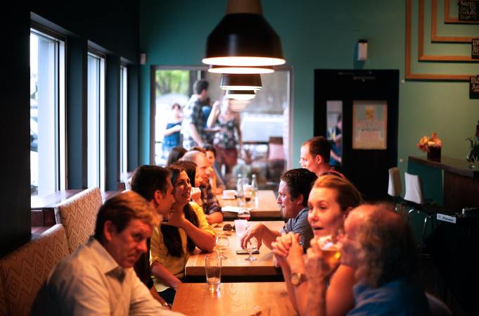 people eating drinking at a restaurant