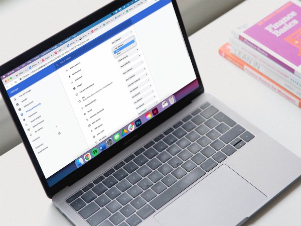 A Macbook laptop on a white desk with the browser notifications settings visible for Google Chrome.