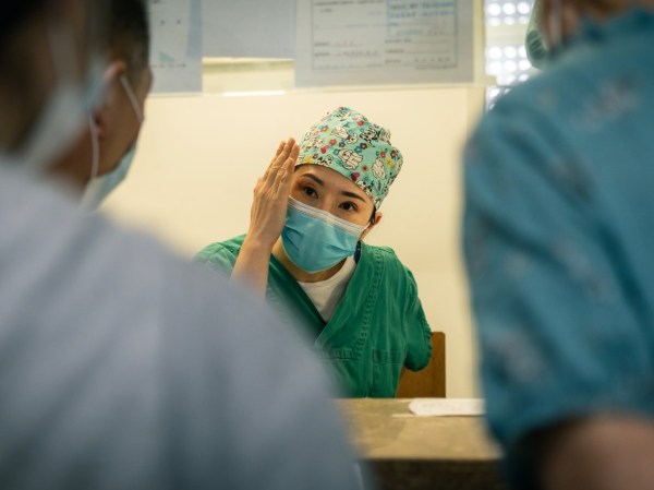 Healthcare worker speaks with patient.