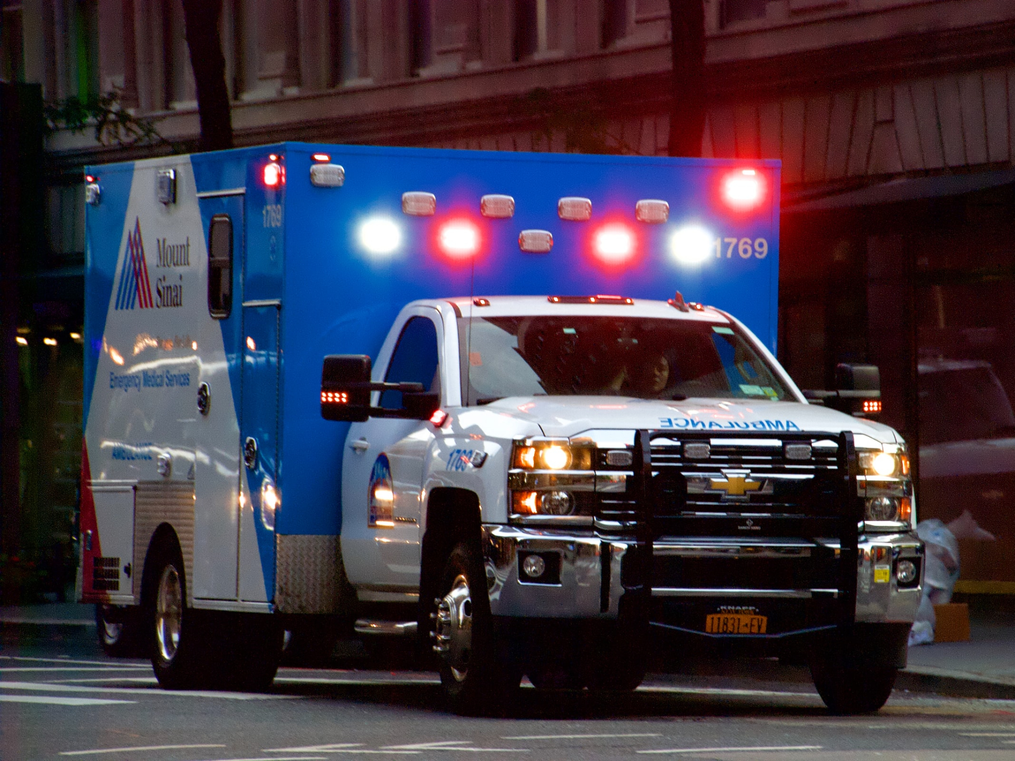 A Mount Sinai ambulance with its lights on in New York City.