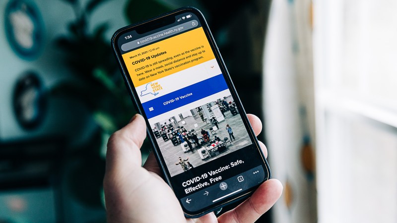 A phone with the New York COVID vaccine site on it