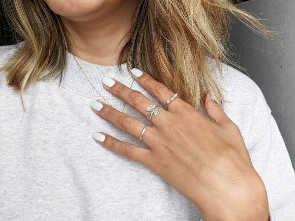 person's hand with silver rings