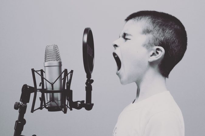 boy screaming into microphone