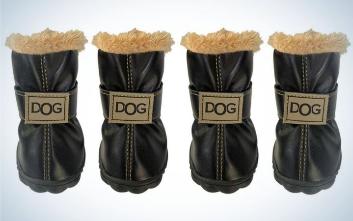  Four black pair of dog boots with beige fur on top of them and dog lettering with capitals in middle of each boot.