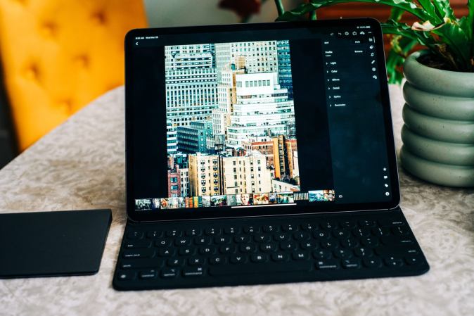 An iPad Pro running Lightroom on a desk