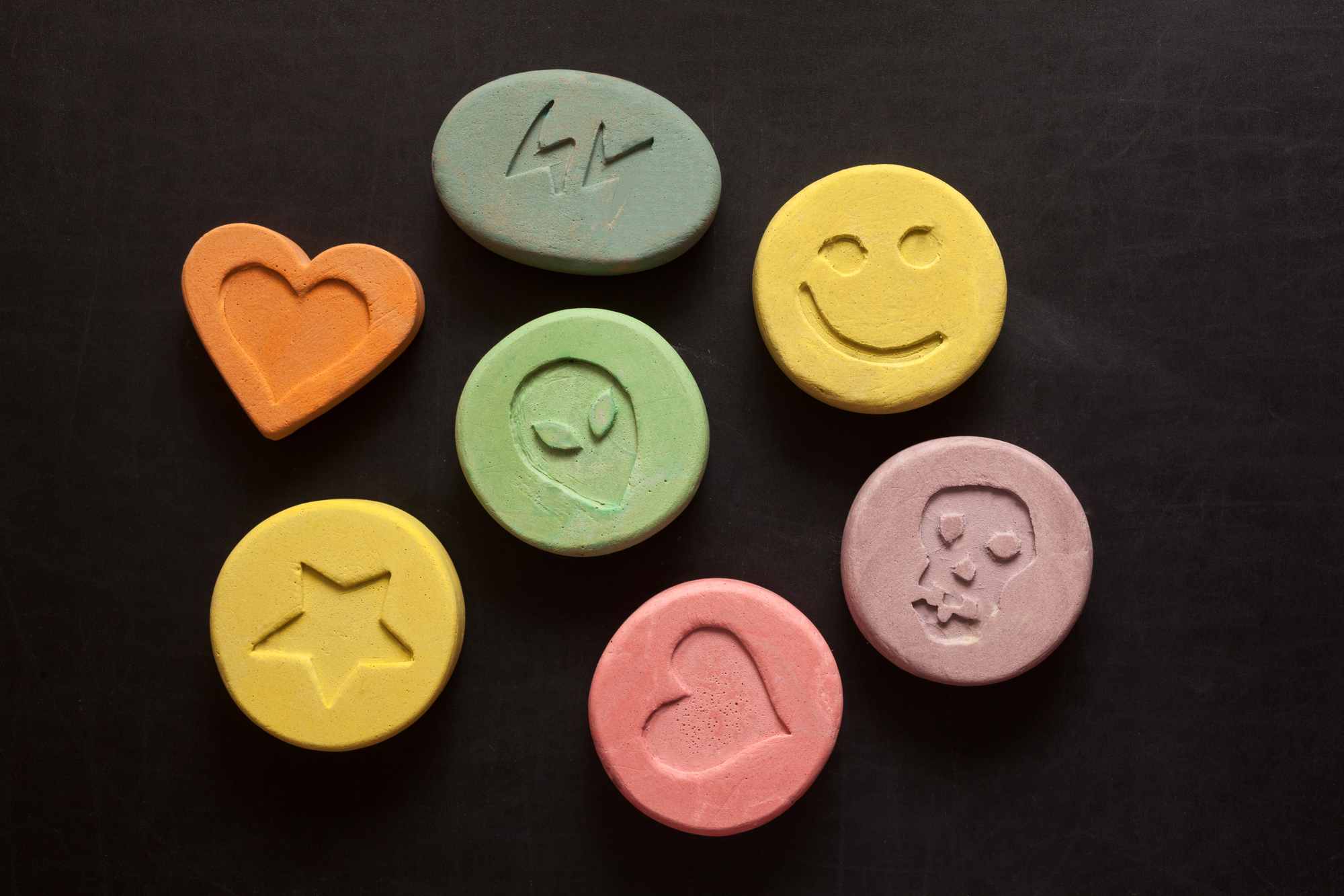 Colorful ecstasy pills with logos