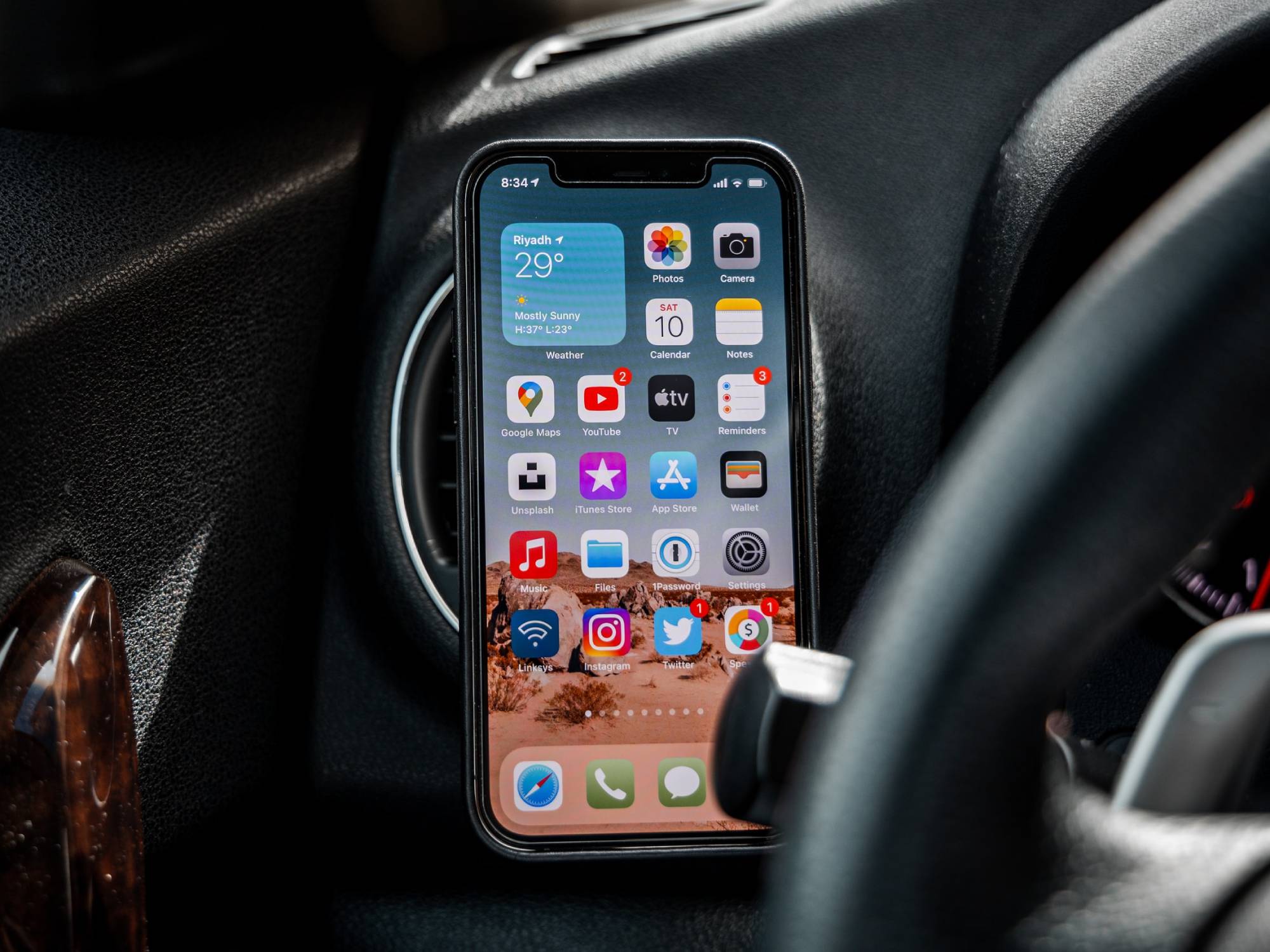 iPhone beside steering wheel in car