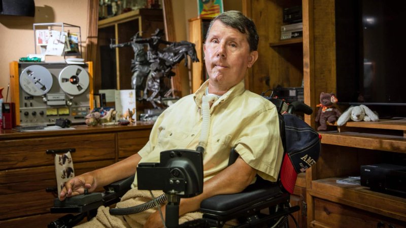 Muscular dystrophy survivor David Taylor in a wheelchair in his Texas house