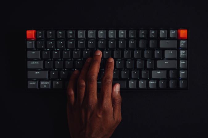 Black hands at a wireless keyboard