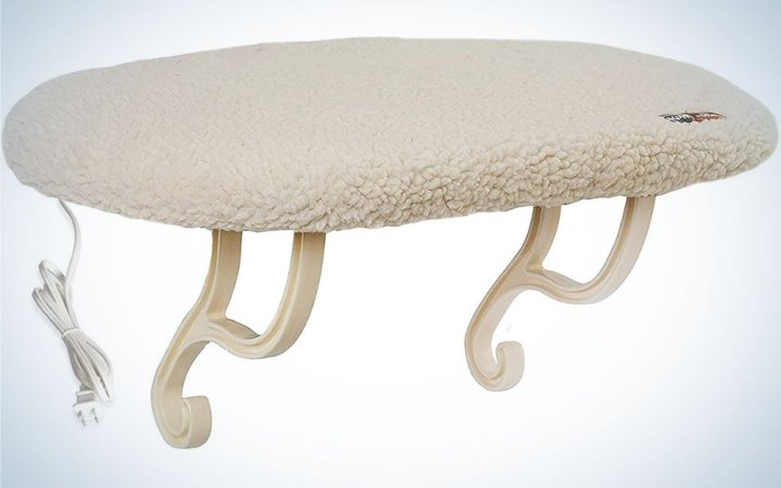  A light beige cat window perch with a thick wool-like backrest, as well as two arched legs to support this perch window.