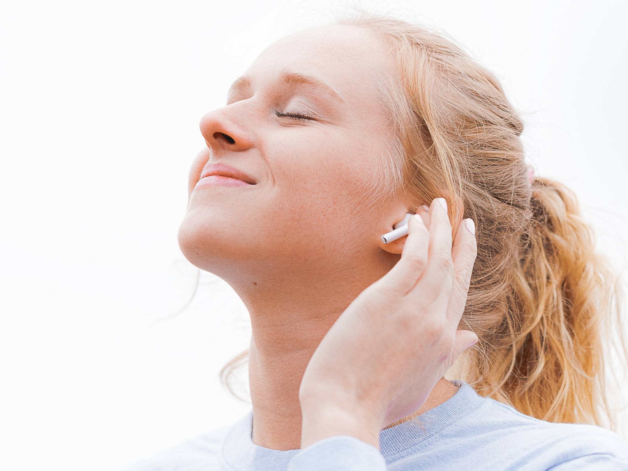 Person smiling with airpods on