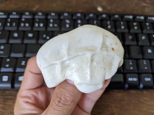 Hands holding slime with crumbs over a keyboard