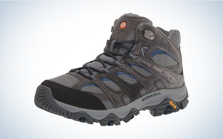  A pair of grey sustainable hiking boots on a blue and white gradient background