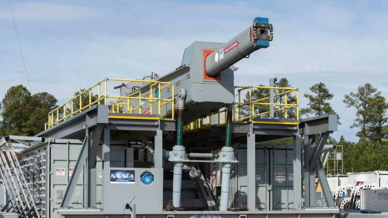 Gray and green metal rail gun on top of platform