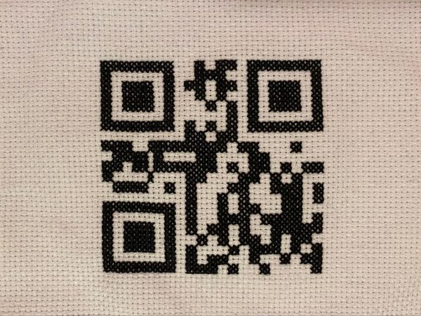 A cross-stitched QR code.