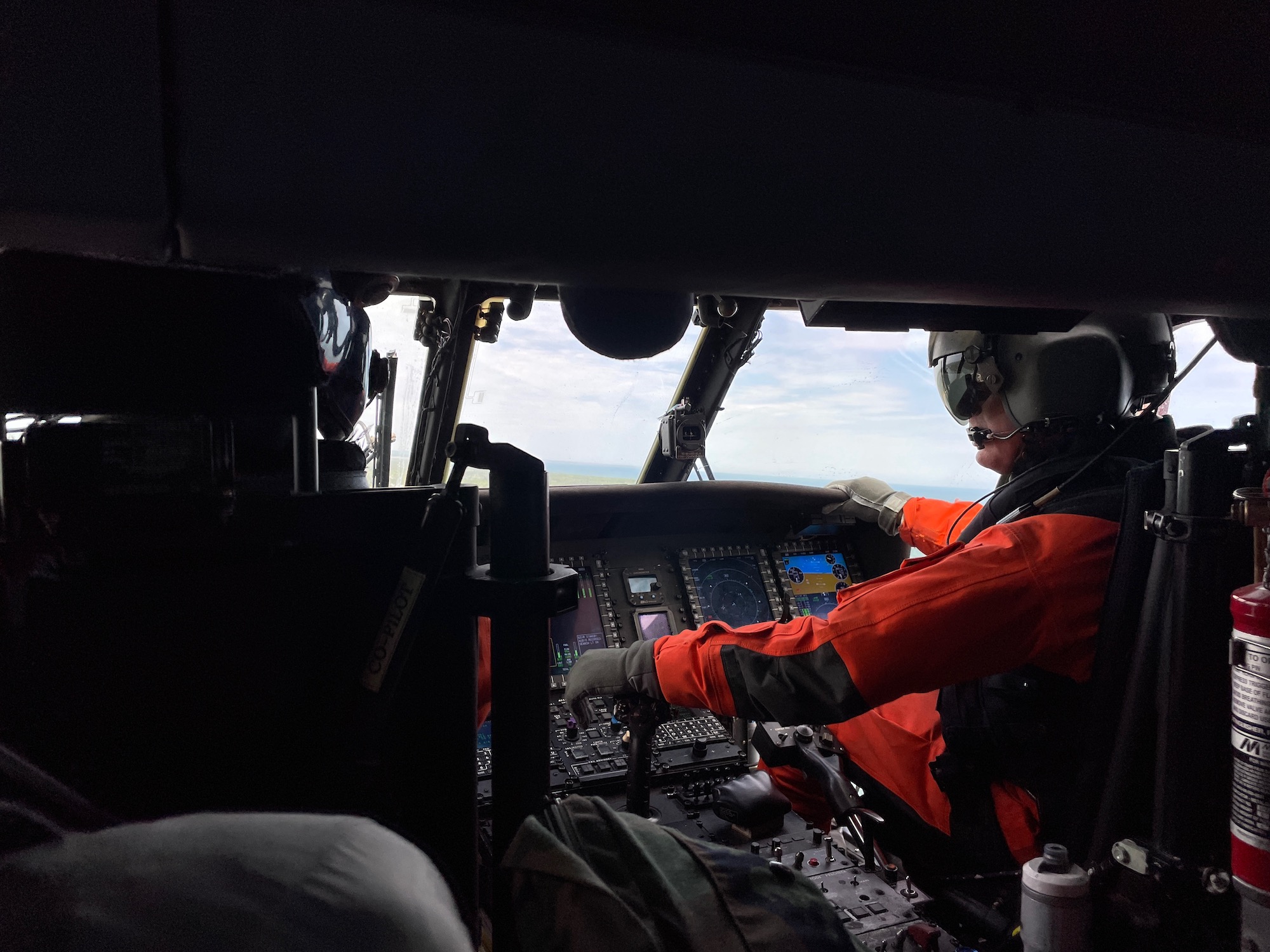 A pilot flies a Coast Guard helicopter