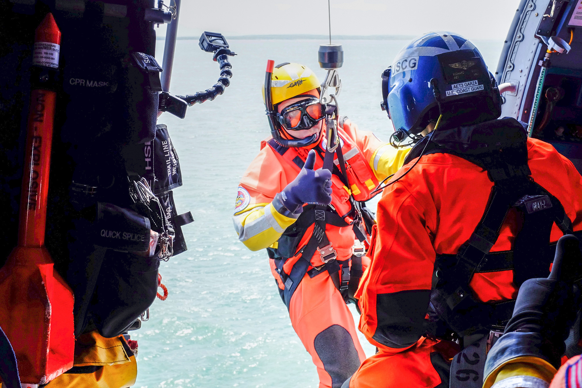 A person is lowered out of a helicopter