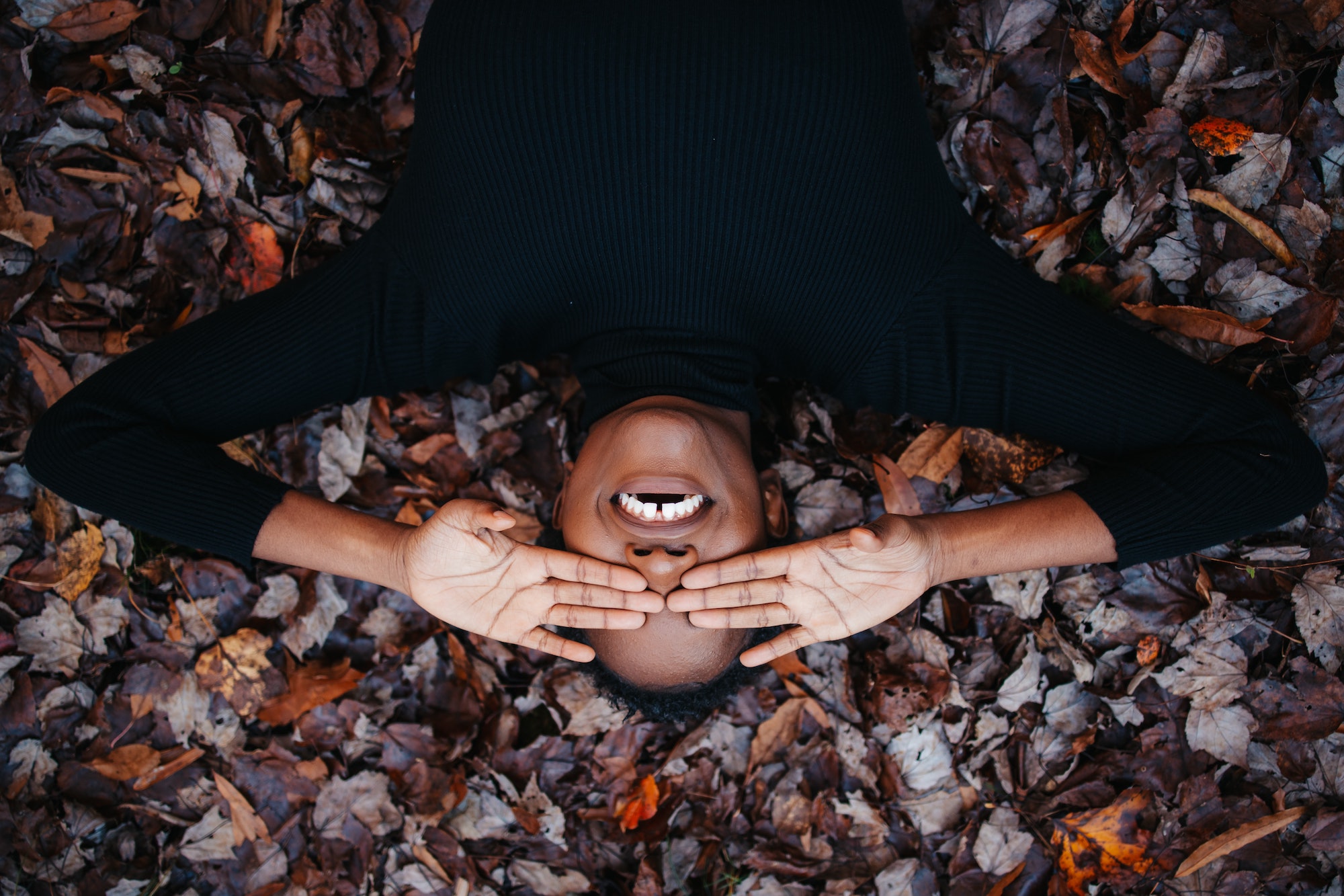 Girl lying down and smiling widely