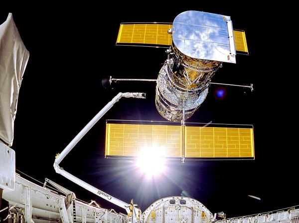 The Hubble Space Telescope, with its yellow solar panels featured prominently.