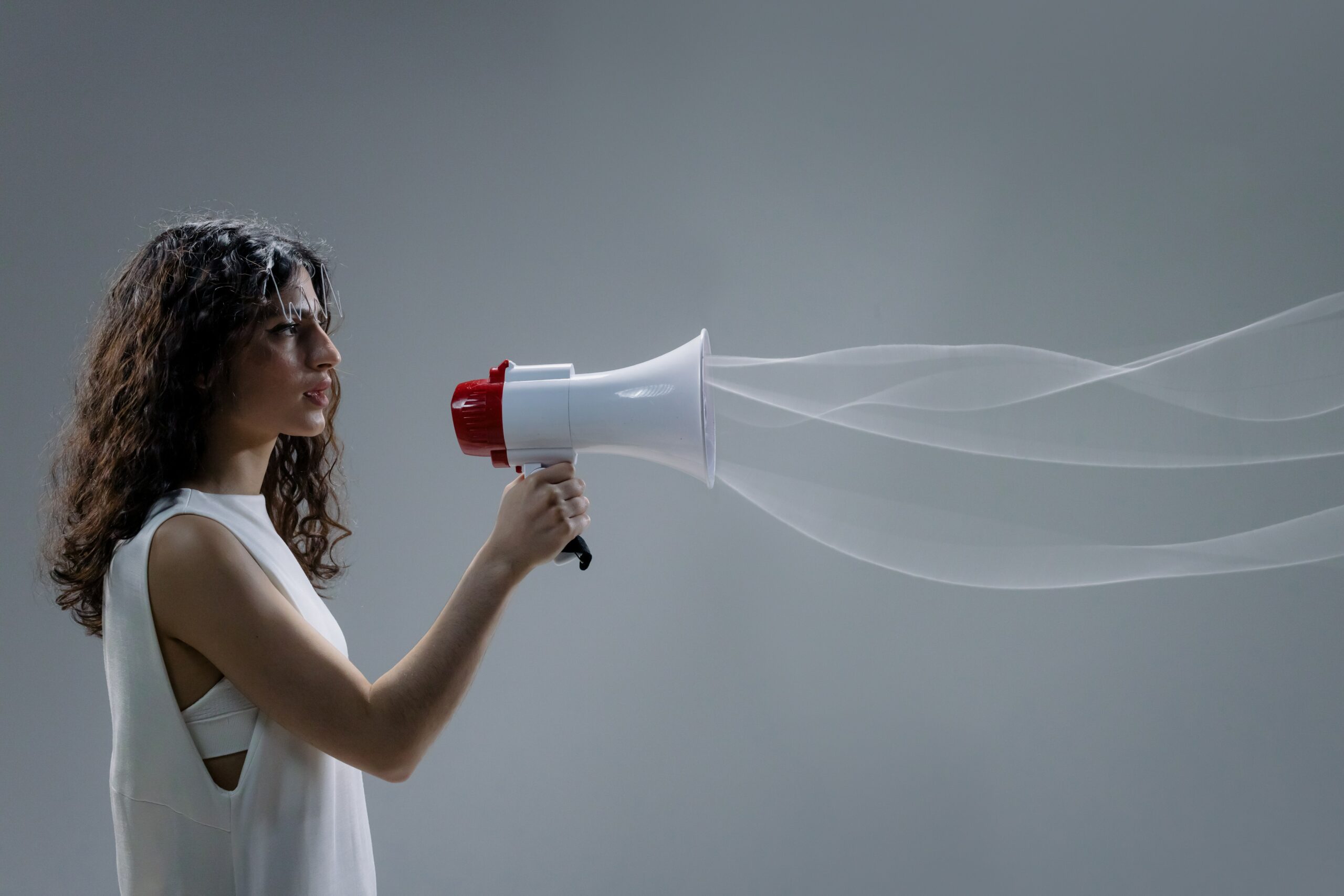 woman talking through a handheld megaphone