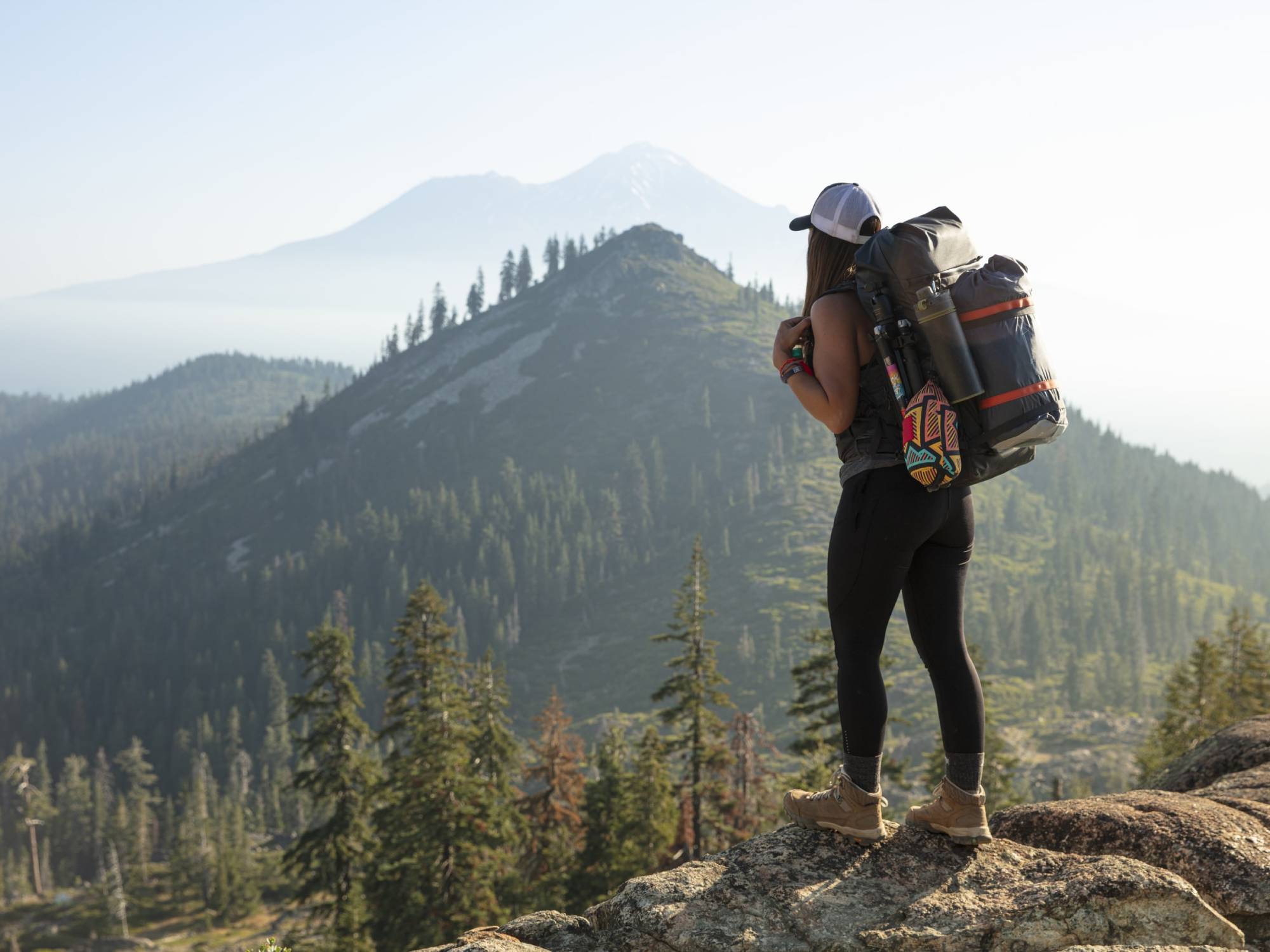 Hikers standing on a rock looking at the horizon