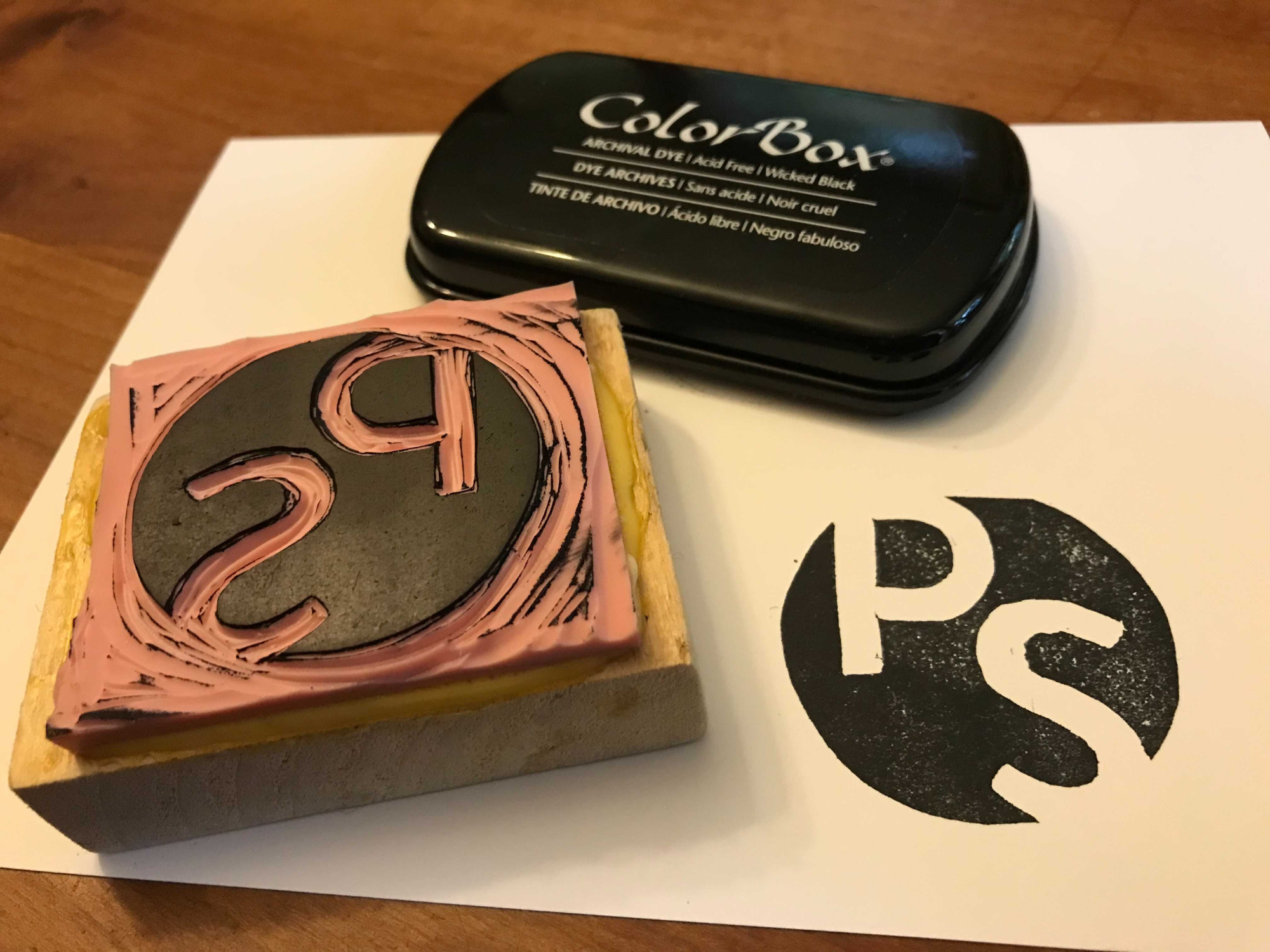 A homemade DIY rubber stamp made in the image of the Popular Science magazine logo.