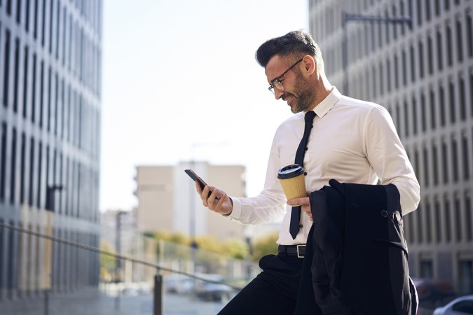 guy looking at his phone in a suit