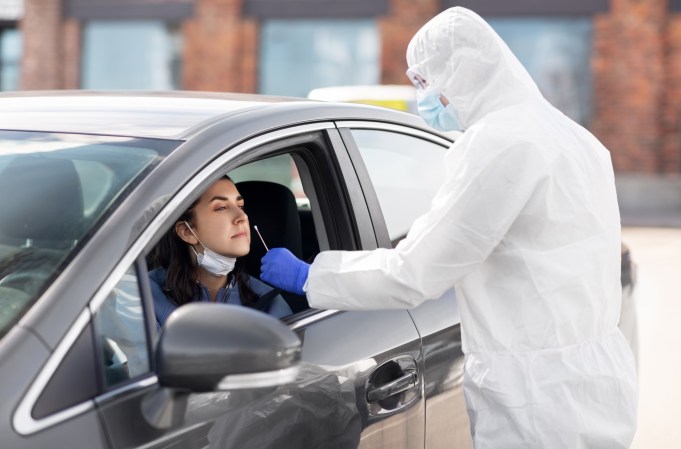 person in car gets covid nose swab test