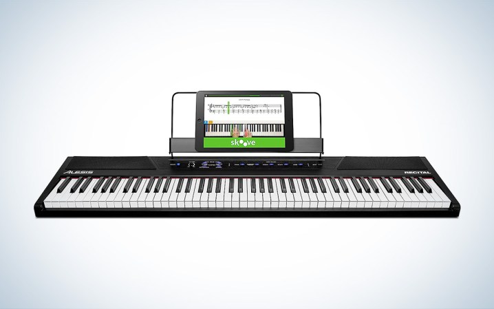  The Alesis Recital 88-key beginner keyboard is placed against a white background with a gray gradient.