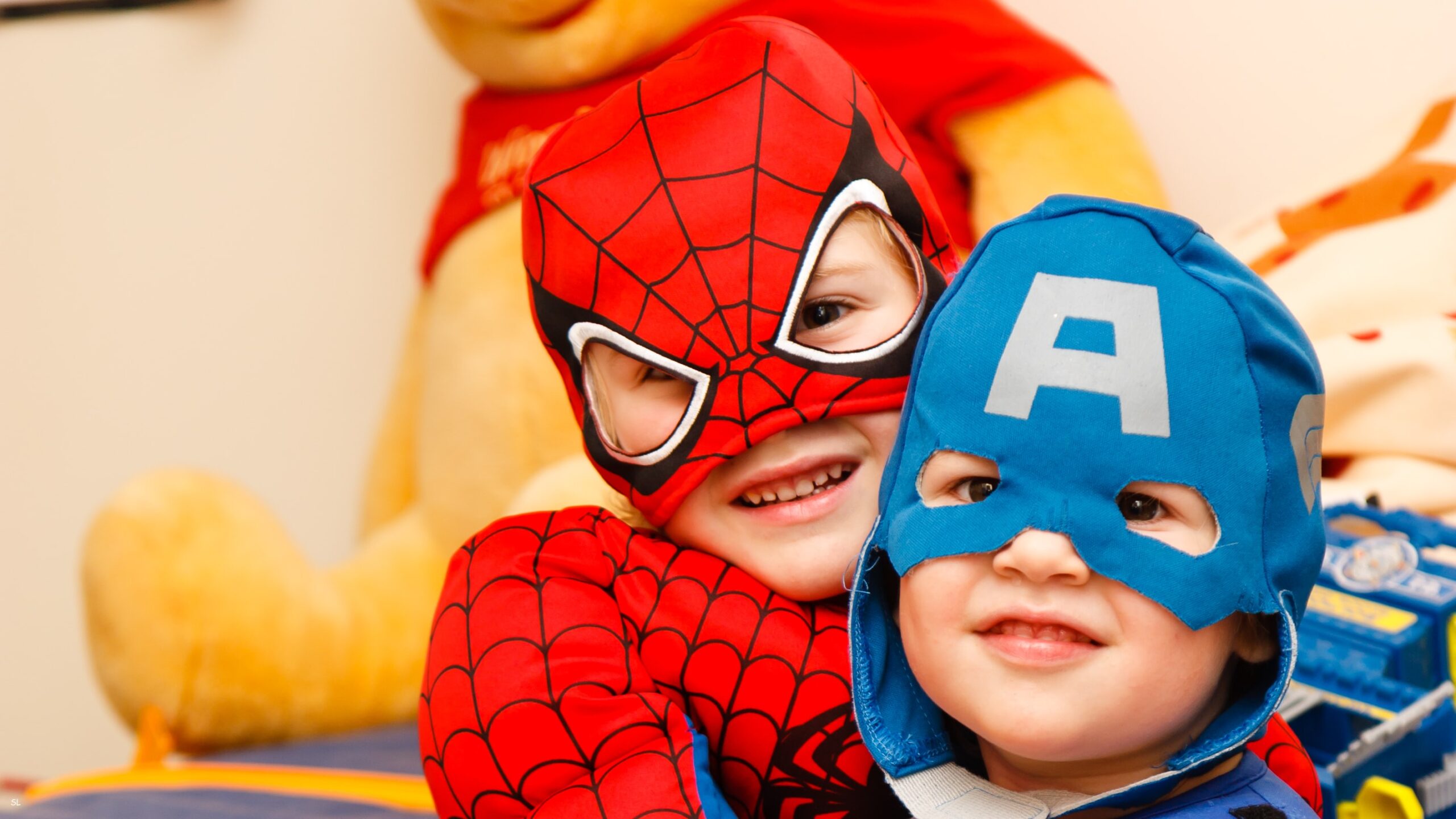 A child dressed as Spider-Man and a child dressed as Captain America