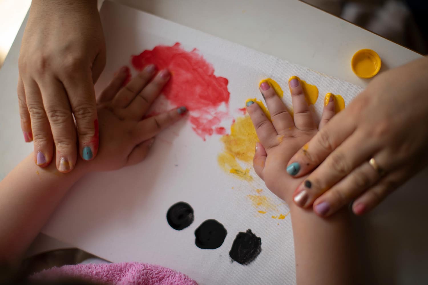 Baby with Zika congenital disease finger painting with mother