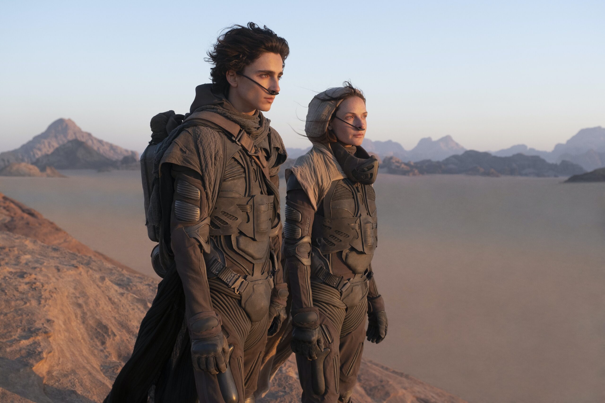 Dune 2021 movie actors looking across the desert of Arrakis