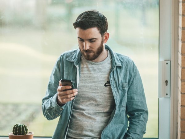 Person looking at phone reading indoors