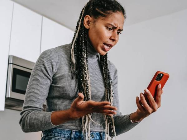 Person in their kitchen yelling at their phone